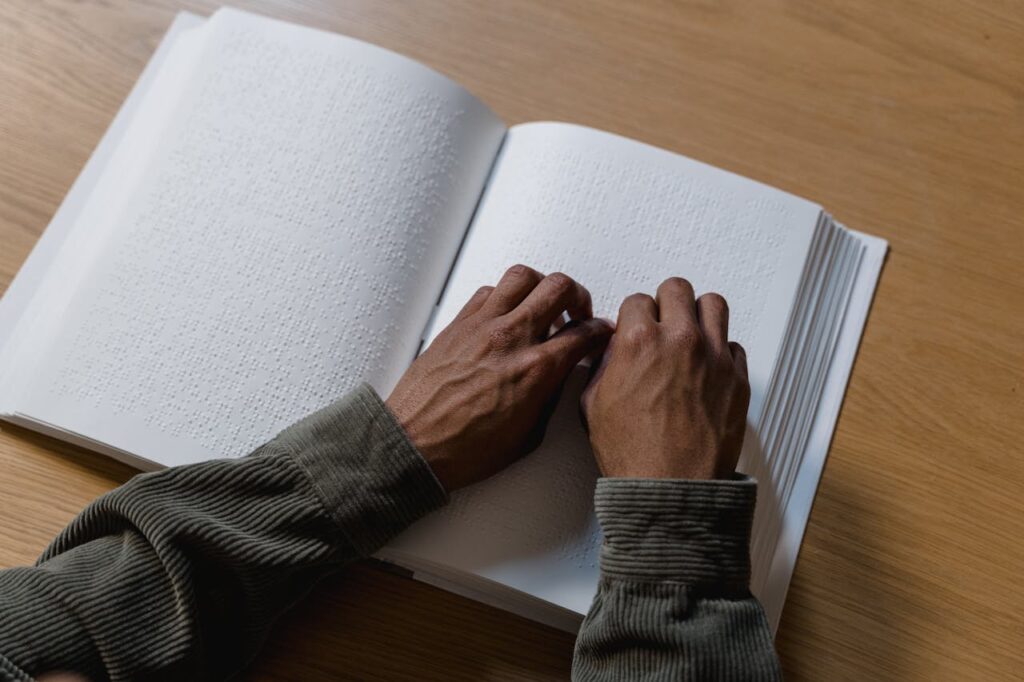Person Reading Book Using Braille System